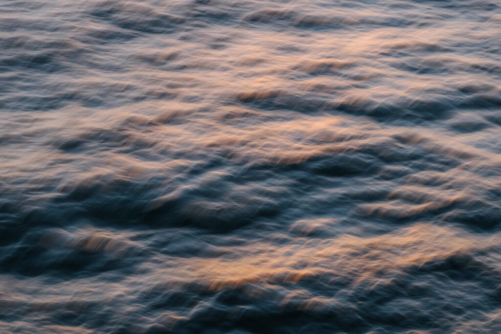Calm body of water reflecting light